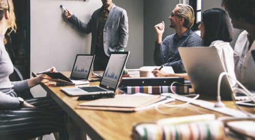 Photo showing people sitting in a business meeting 